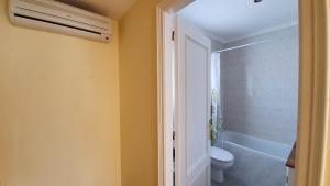 a bathroom with a white toilet and a shower at Villa Pals Carles Piscina in Pals +28 photos
