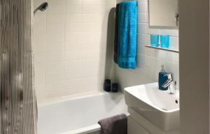 a bathroom with a white tub and a sink and a shower at Gorgeous Apartment In Büsum With Wifi in Büsum +6 photos