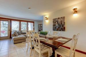 a dining room and living room with a table and chairs at 7th Mountain Bliss in Bend
