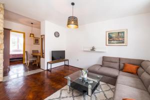 a living room with a couch and a table at IL MURO apartment in Zadar