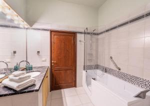a bathroom with a tub and a sink and a shower at Ludyta House in centro Arezzo in Arezzo +23 photos