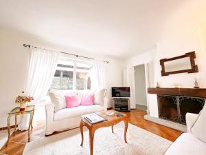 a living room with a white couch and a fireplace at Casa Via Saleggi 10 in Ascona