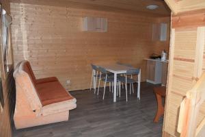 a room with a table and chairs in a cabin at Marco in Sarbinowo