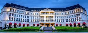 a large white building with a courtyard in front of it at Nemacolin in Farmington