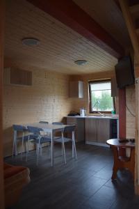 a kitchen with a table and chairs in a room at Marco in Sarbinowo +21 photos