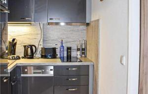 a kitchen with a stove and a counter top at Gorgeous Apartment In Büsum With Wifi in Büsum