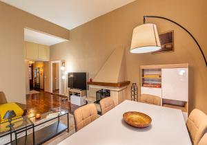 a living room with a table and a dining room at Ludyta House in centro Arezzo in Arezzo