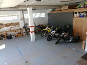a garage with two motorcycles parked in it at Casa Ferro in Plan