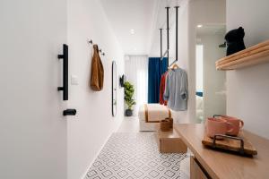 a living room with a white wall and a white floor at Margaret Luxury Suites in Naxos Chora