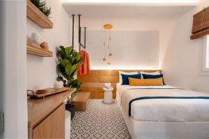 a small bedroom with a bed and a desk at Margaret Luxury Suites in Naxos Chora