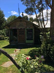 a small building with a dog on top of it at Bosque Patagonico Cabañas y Camping in Hornopiren