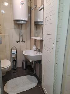a small bathroom with a sink and a toilet at Guest House Ilica2rooms in Zagreb