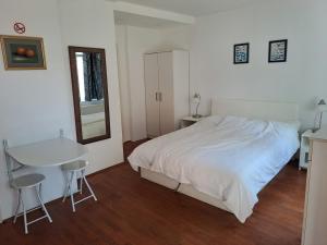 a bedroom with a bed and a table and chairs at Guest House Ilica2rooms in Zagreb