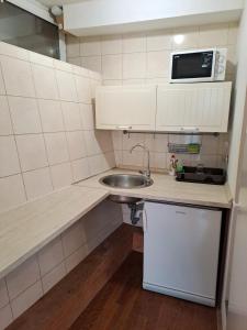 a small kitchen with a sink and a microwave at Guest House Ilica2rooms in Zagreb