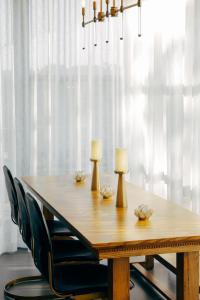 a dining room table with two lamps and chairs at Colton House Hotel in Austin