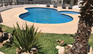 a swimming pool in a yard with a landscaping at Fantastic & Cozy #3: Condo Close to the Beach in Ensenada