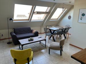 a living room with a couch and a table and chairs at MLH1departamentos in Ushuaia