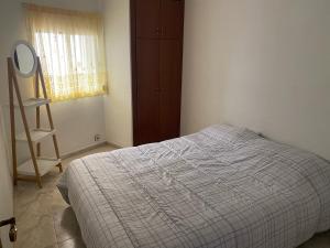 a bedroom with a bed and a dresser and a window at Salou Llevant parking gratuit in Salou