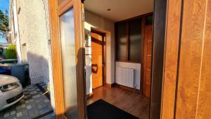 an open door to a room with a hallway at Self-catering extended family home in Edinburgh