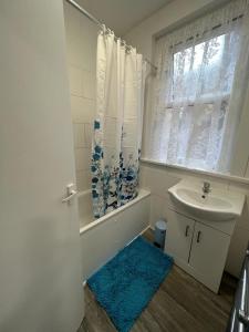a bathroom with a sink and a toilet and a window at WoodGreen house in London