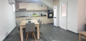 a kitchen with a wooden table and chairs in it at Villa Alma in Vipava +2 photos