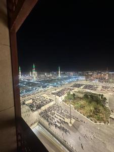 a view of a crowded beach at night at Emaar Elite Al Madina Hotel in Medina