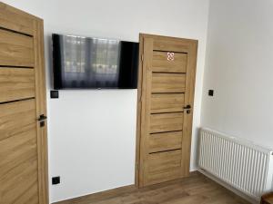 a room with two wooden doors and a window at Irys 1 in Tychy