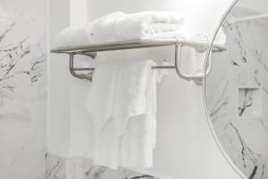 a bathroom mirror with white towels on a towel rack at Starlite Hotel in Miami Beach +75 photos