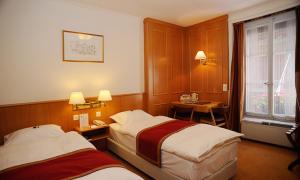 Cama ou camas em um quarto em Hotel AlaGare