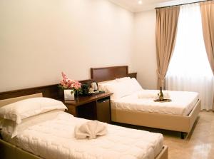 a bedroom with two beds and a window at Esposizione Boutique in Rome