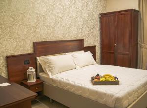 a bedroom with a bed with a tray of fruit on it at Esposizione Boutique in Rome