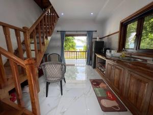 a kitchen with a wooden staircase and a sink at Digwa Beach Chalet in La Digue