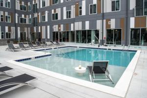 a swimming pool in a building with chairs at Modern Home 2BR 2BA Free Off-Street Parking & Wifi in Baltimore