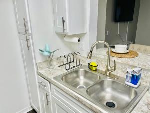 a kitchen with a sink and a counter top at Deluxe Stays in Kissimmee