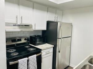 a kitchen with a stove and a refrigerator at Deluxe Stays in Kissimmee