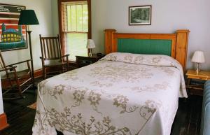 a bedroom with a bed with a white comforter at Lakeside Inn in Lakeside