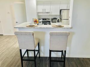 a kitchen with a counter and two chairs at a kitchen island at Deluxe Stays in Kissimmee