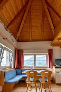 ein Wohnzimmer mit einem blauen Sofa und 2 Stühlen in der Unterkunft Santlhof-Weissburgunder in Kurtatsch