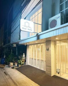 a building with a sign that reads newer homes at River Home Bangkok in Bangkok