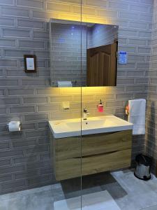 a bathroom with a sink and a mirror at Digwa Beach Chalet in La Digue