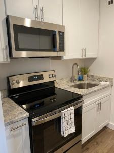 a kitchen with a stove and a microwave at Adorable Studio Apartment in Gadsden, AL in Gadsden