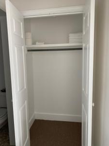 a closet with white walls and a white door at Adorable Studio Apartment in Gadsden, AL in Gadsden