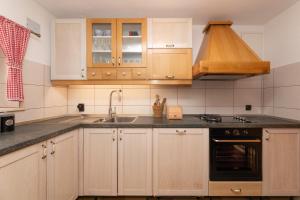a kitchen with wooden cabinets and a sink at "Villa Kostela"-Villa in nature with 4 bedrooms, 2 bathrooms and 2 kitchens in Ložišće