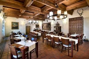 a restaurant with tables and chairs in a room at Hotel Chateau Orlice in Letohrad