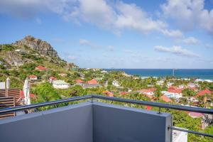 a balcony with a view of the ocean at Maison Palmier Blanc in Saint Barthelemy