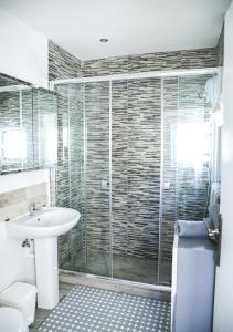 a bathroom with a sink and a glass shower at Casa Elizabeth in Jávea +38 photos