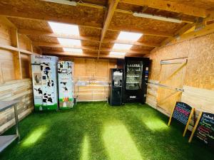 a kitchen with two refrigerators in a room with grass at Ketburn Shepherds Hut at Balnab Farm in Newton Stewart