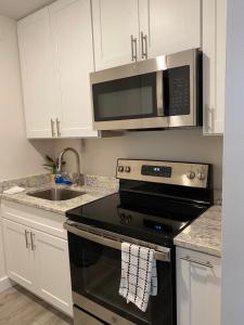 a kitchen with a stove and a microwave at Quaint studio apartment in Gadsden, Al in Gadsden