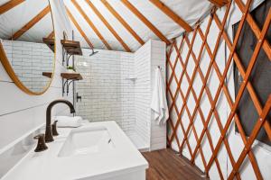 a bathroom with a sink and a mirror at OT 3515J Texas Yurt Haus Javelina in New Braunfels