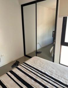 1 dormitorio con 1 cama con puerta corredera de cristal en Smart Studio Nano en SantaCruz de la Sierra - Barrio Equipetrol, en Santa Cruz de la Sierra 5 fotos más